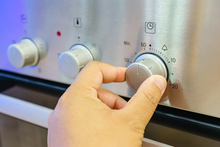 Close up male hand while using the microwave in his kitchenの写真素材