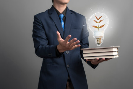 Idea lamp in businessman hand, save earth conceptの写真素材