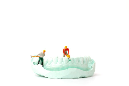 Miniature people : Worker team repairing a tooth ,Healthcare and medical concept