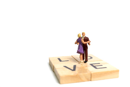 Miniature people, Couple romantic dancing on white background , Valentine's day conceptの写真素材