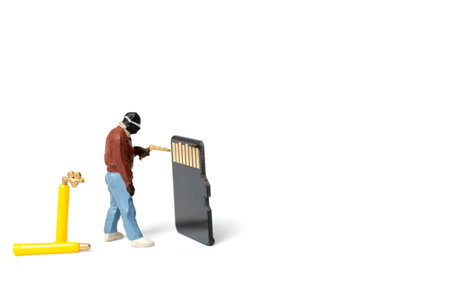 Miniature people technician fixing pile of sd cards on white background with copy space.の写真素材