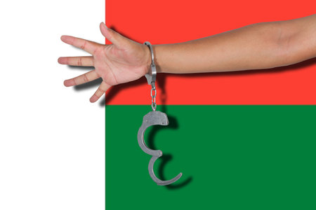 handcuffs with hand on Madagascar flag