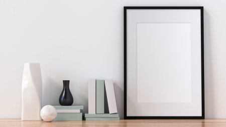 A picture frame on the floor with a flower vase.