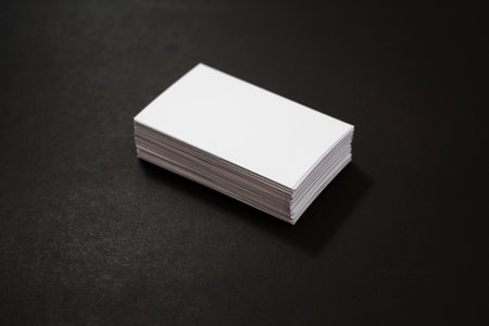 blank business cards stack up on Black background