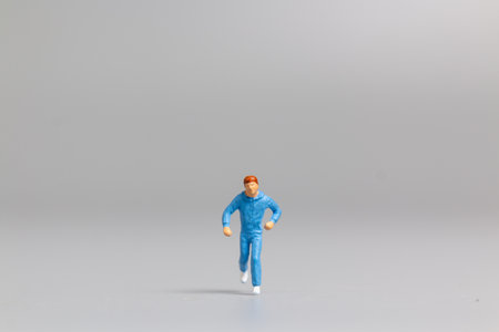 Miniature people Running on gray background and free space for textの写真素材