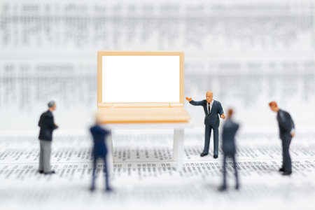 Miniature people: Businessman thinking with project for presenting investment on White screen computer laptop , Business and technology conceptの写真素材