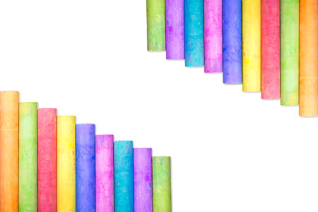 Row of rainbow colored chalk isolate on white background
