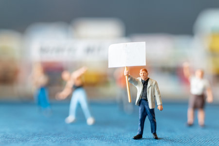 Miniature people, protesters holding signs, raising their hands for revolution or protesting Concept