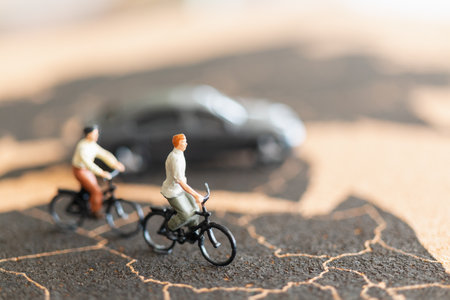 Miniature people travellers with bicycle on World map backgroundの写真素材
