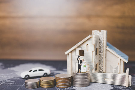 Miniature people bride and groom with coins money at home , Success family conceptual.の写真素材