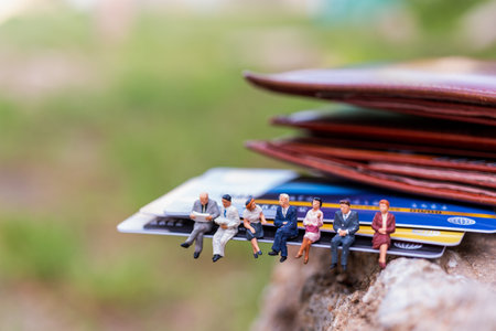 Miniature people : business people sitting on Credit card , Business and Finance conceptsの写真素材