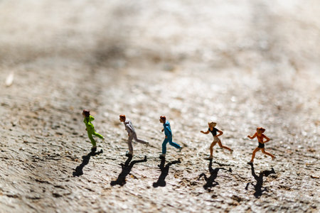 Miniature people : Group of people are running on concrete floor , Healthy and lifestyle conceptの写真素材