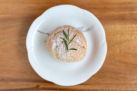 Choux cream placed on a white plate and wooden background