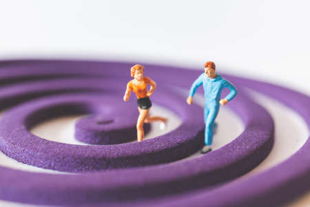 Miniature people : Couple Runnig on the purple fieldの写真素材