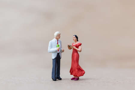 Miniature people , Couple dancing on wooden backgroundの写真素材