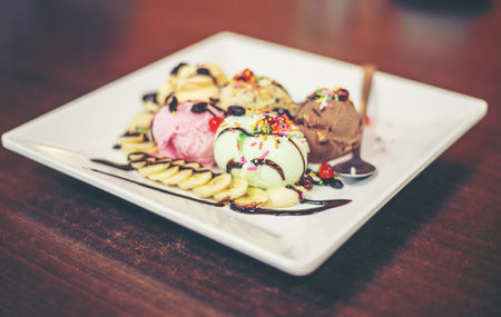 ice cream sundae vanilla strawberry chocolate lemon scoops with banana.