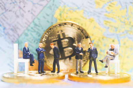 Miniature people: Businessman on stack of coins , business success concept.