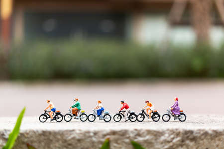 Miniature people travellers with bicycle in the parkの写真素材