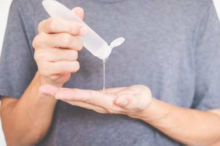 Man hands using wash hand sanitizer gel dispenserの写真素材