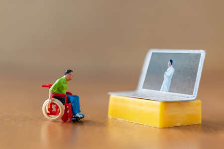 Male patient talk consult with doctor using video call on laptop , online doctor conceptの写真素材