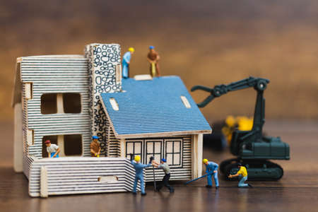 Miniature people : worker team for building homeの写真素材