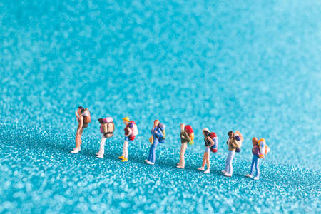 Miniature Backpacker , Tourist people on blue glitter backgroundの写真素材