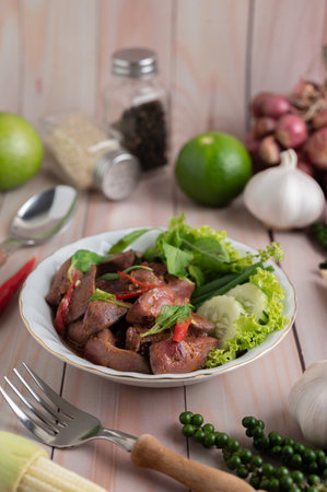 Holy Basil Fried Rice with Chicken Heart on a White Wooden Floor.の写真素材
