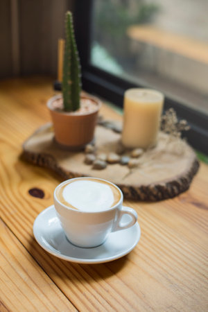 A cup of hot cappuccino in wood tableの写真素材