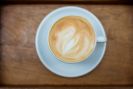 hot latte art on wood table background