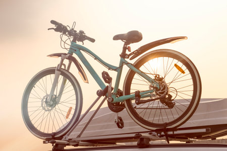 Bike and car trunk close up on sky background. Travelling by carの写真素材