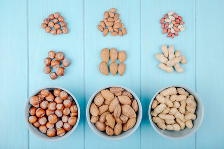top view of mixed nuts in shell and without shell on blue backgroundの写真素材