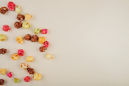 top view of skittles popcorn on left side and white background with copy spaceの写真素材
