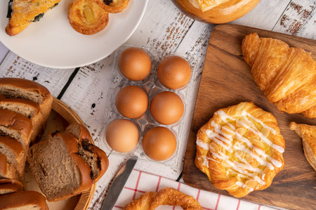 Various breads and eggs on red white cloth. Selective focus.の写真素材
