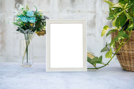 The picture frame is placed on the cement table.