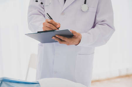 Senior male retirement patient receive medical treatment record by physician at the hospital for medical healthcare service.の写真素材