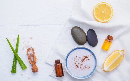 Homemade skin care and body scrub with natural ingredients lemon slice ,himalayan salt ,aromatic oils and lavender body scrubs set up on white wooden background with flat lay.の写真素材