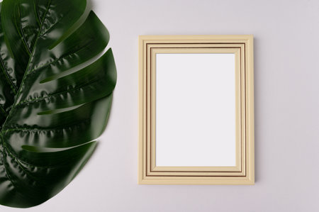 white photo frame and leaf on white backgroundの写真素材
