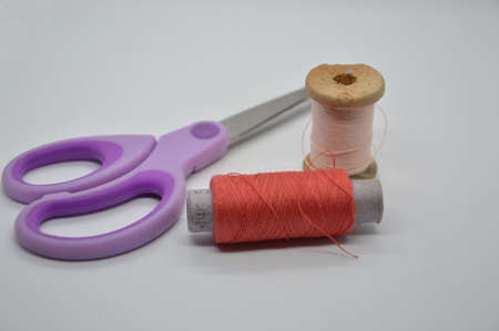 Threads and spools for sewing clothes on a white the background