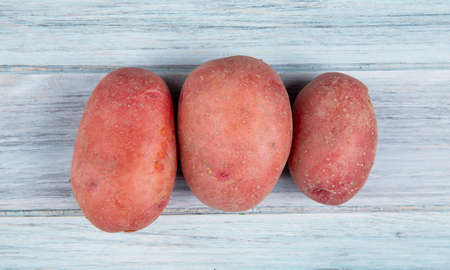 top view of red potatoes on wooden backgroundの写真素材