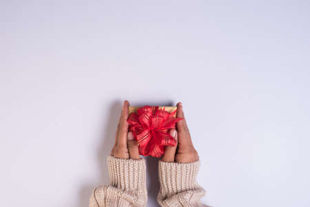 Top view Hand holding gift box on work spaceの写真素材