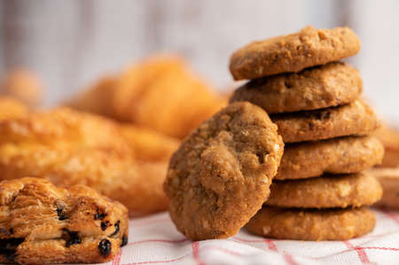 Cookies stacked on a white-red cloth. Selective focus.
