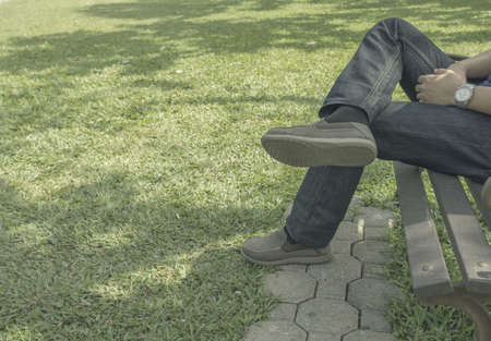 Sad man sitting alone in the park