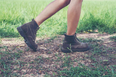 Young adventure woman feet walking on gravel in the forest..の写真素材