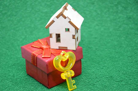 Receiving keys to his apartment building on a background a of green grass