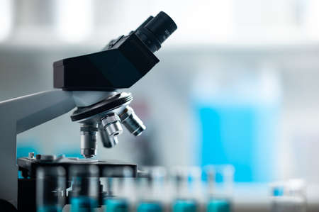 professional microscope in laboratory, science equipment and medical tools to looking micro scale, microbiology and medicine research in laboratory with microscopeの写真素材
