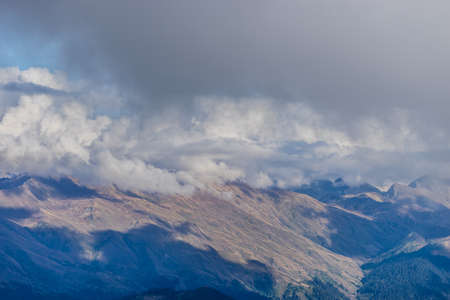 the top of the mountain on the background of the autumn sky and cloudsの写真素材