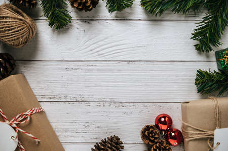 Small gift used to decorate the Christmas tree is on a white wooden floor.