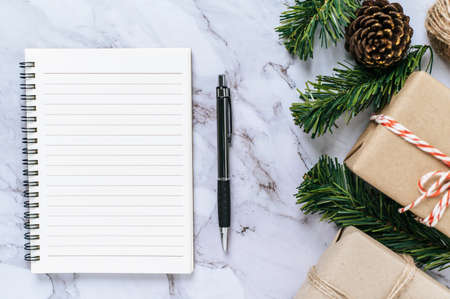 A notebook placed on a cement background with giftshop used to decorate the Christmas tree.