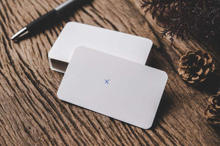 blank card and pen is placed on wood background