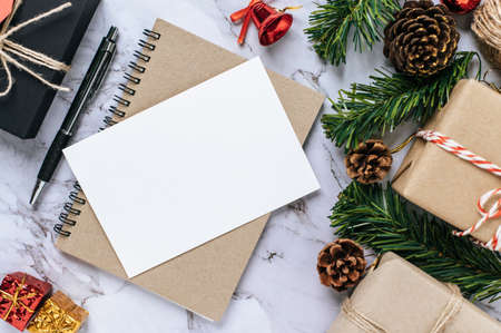 A notebook placed on a cement background with giftshop used to decorate the Christmas tree.